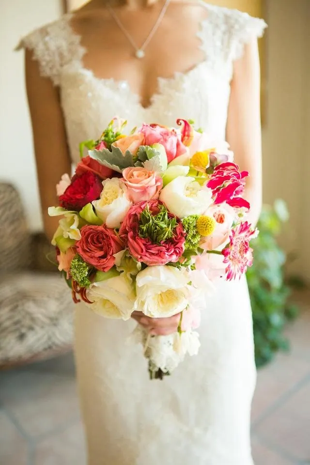 Bride holding a colorful bouquet by Margaret Rose Floral Design.