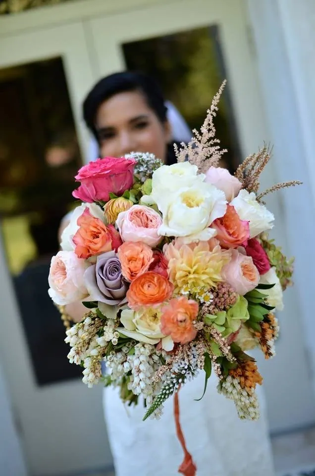 Bride holding a pastel bouquet by Margaret Rose Floral Design.
