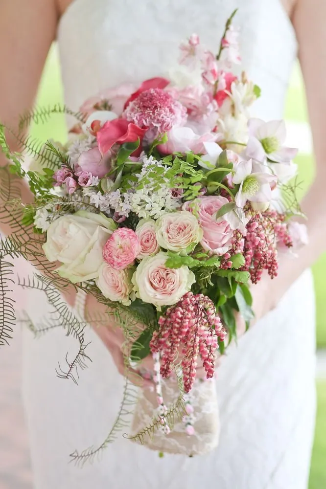 Bride holding a pink and green bouquet by Margaret Rose Floral Design.