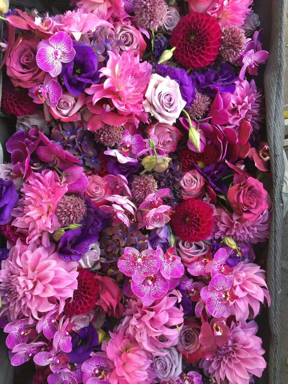 Dense magenta, purple, and pink floral design with layered flowers and vivid texture.