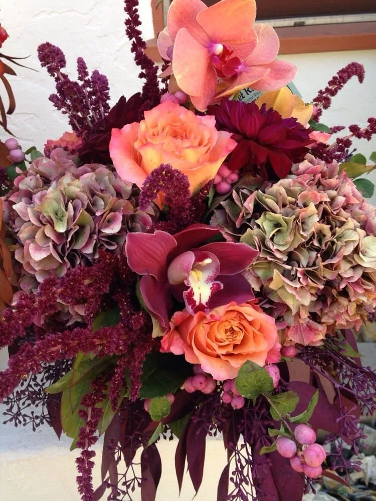 Moody burgundy, orange, and pink wedding bouquet.