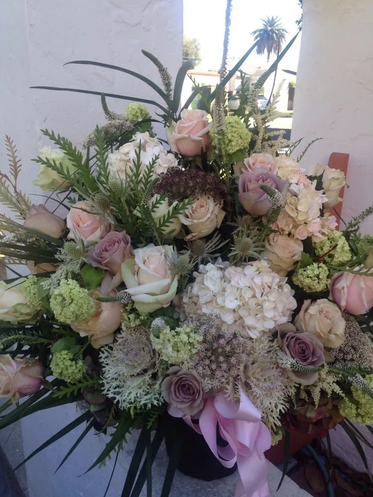 Soft blush and white bridal bouquet with garden texture.