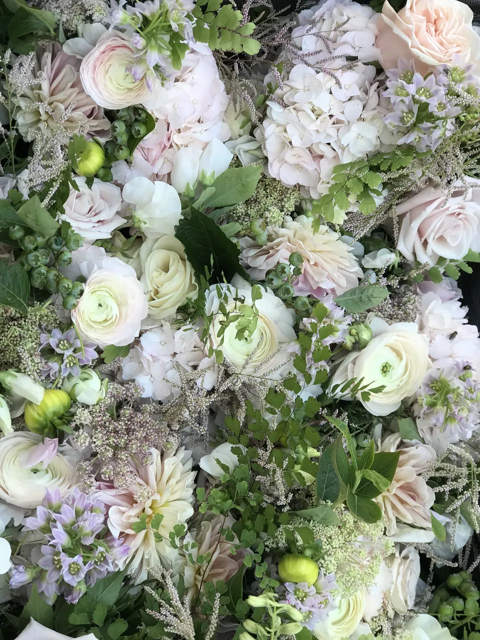 Soft white and pale green floral installation detail with romantic garden texture.